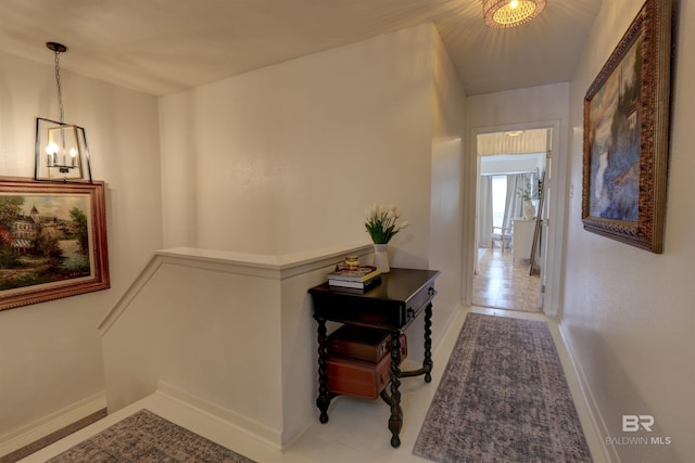 hallway featuring a notable chandelier