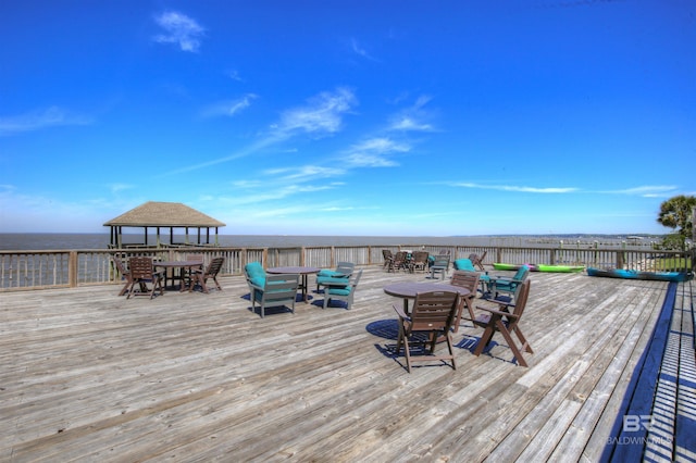 deck with a gazebo and a water view