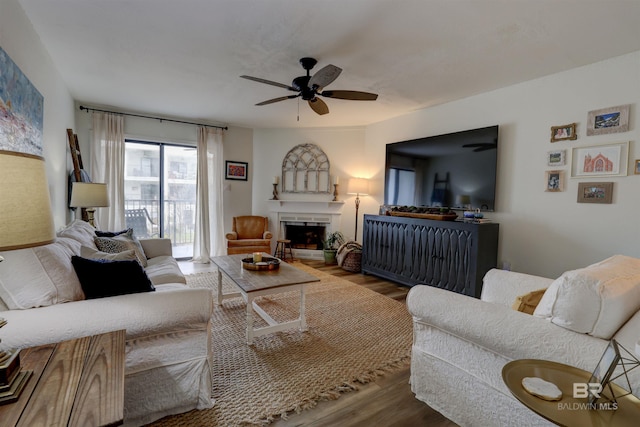 living room with hardwood / wood-style floors and ceiling fan