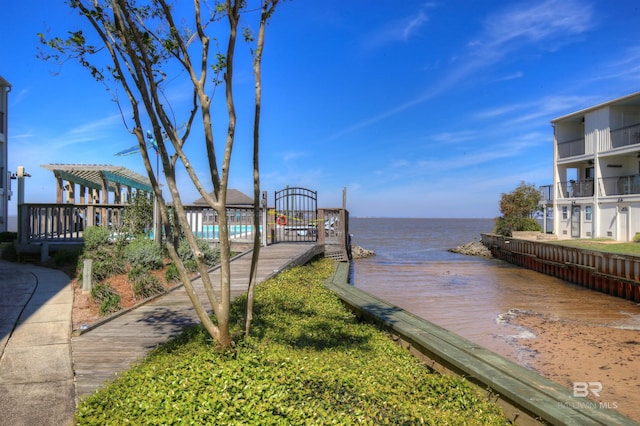 dock area with a pergola and a water view