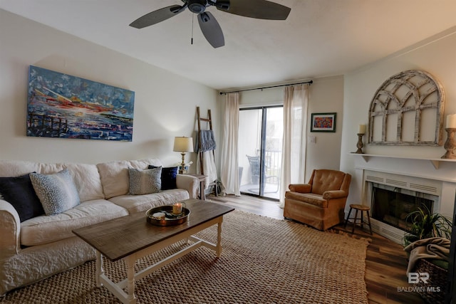 living room featuring hardwood / wood-style flooring and ceiling fan