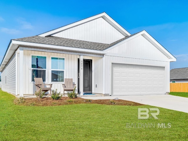 16770 Prado Loop, Loxley, AL 36551 - view of front of home featuring a shingled roof, a front yard, concrete driveway, an attached garage, and covered porch