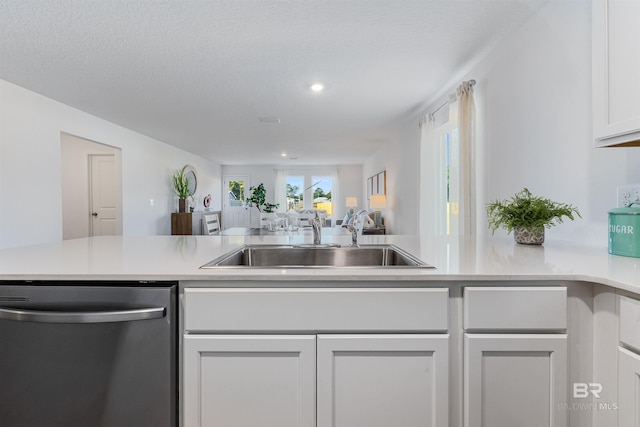 16770 Prado Loop, Loxley, AL 36551 - kitchen featuring dishwasher, light countertops, white cabinetry, open floor plan, and recessed lighting