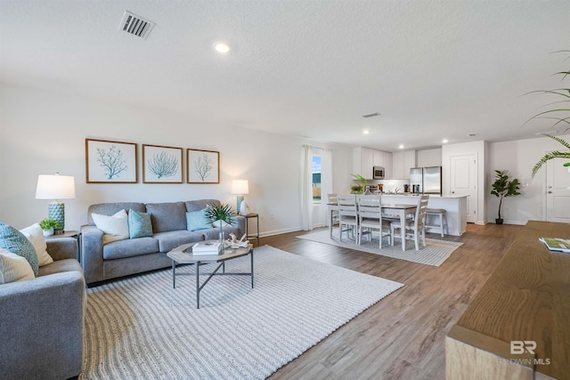16770 Prado Loop, Loxley, AL 36551 - living area with light wood-style floors, recessed lighting, and a textured ceiling