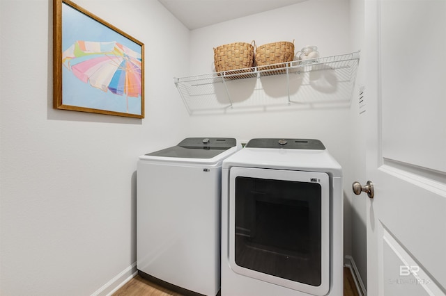 16770 Prado Loop, Loxley, AL 36551 - laundry room featuring washing machine and dryer and wood finished floors