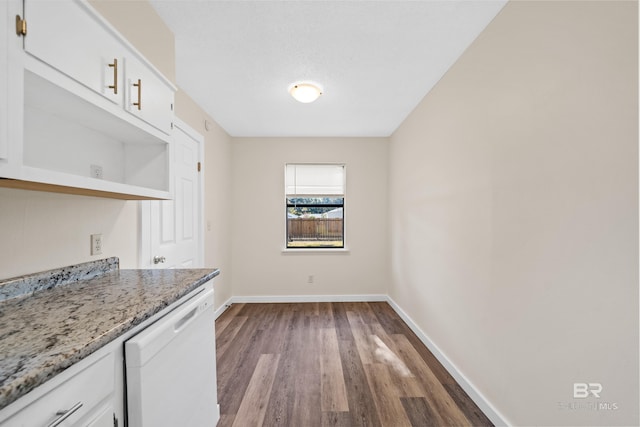 kitchen featuring white cabinets, dishwasher, light stone countertops, and hardwood / wood-style floors