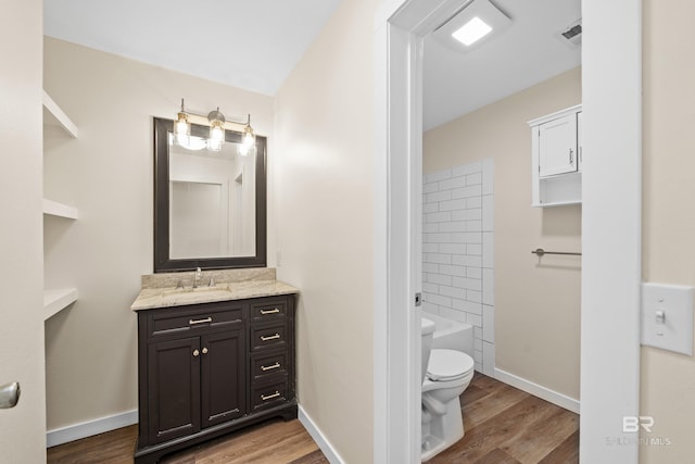 full bathroom featuring hardwood / wood-style floors, vanity, toilet, and shower / bathing tub combination