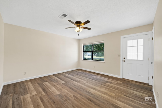 interior space featuring ceiling fan, a textured ceiling, and hardwood / wood-style flooring