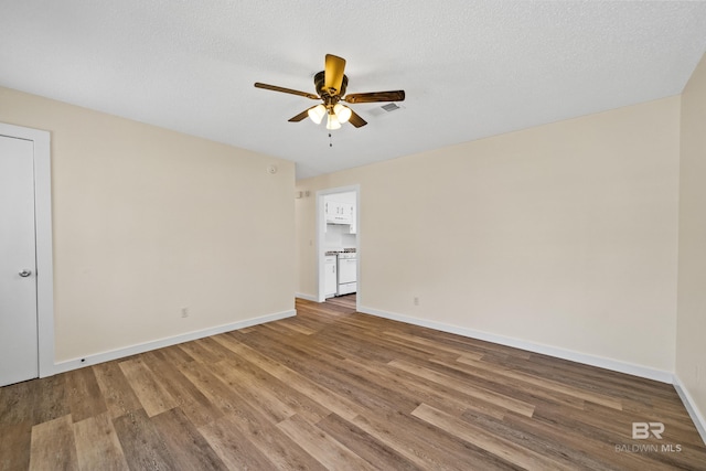 unfurnished room featuring a textured ceiling, hardwood / wood-style flooring, and ceiling fan