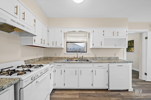 kitchen with white cabinetry, light stone counters, white appliances, and sink