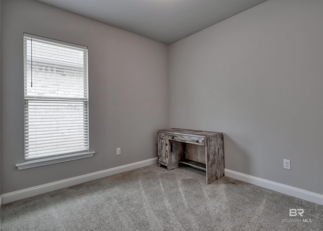 carpeted empty room with baseboards