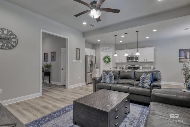 living room featuring recessed lighting, a ceiling fan, light wood-type flooring, and visible vents