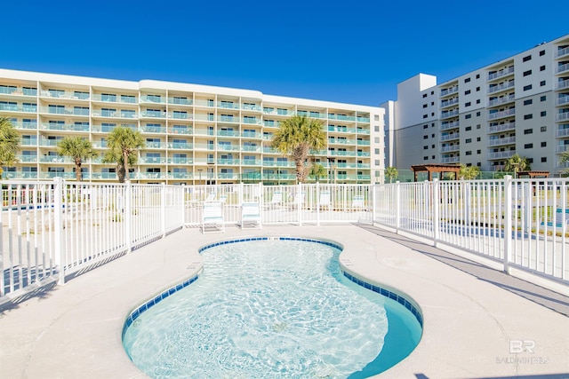 view of swimming pool with fence