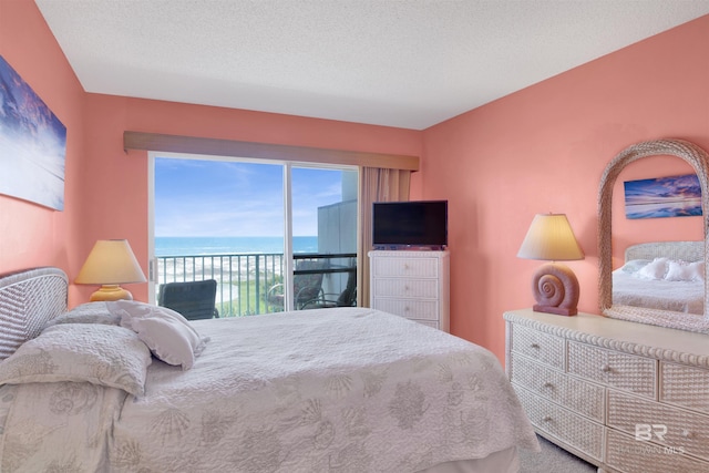 bedroom featuring a textured ceiling and access to exterior