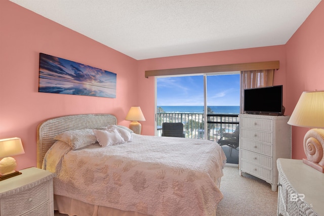 carpeted bedroom featuring access to outside and a textured ceiling