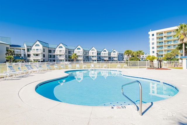 pool featuring a patio area and fence