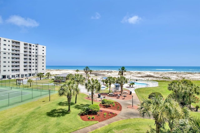 property view of water with fence and a beach view