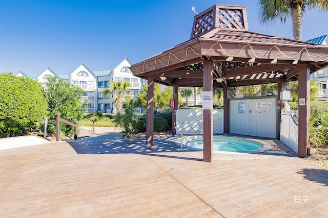 surrounding community with a hot tub and a gazebo