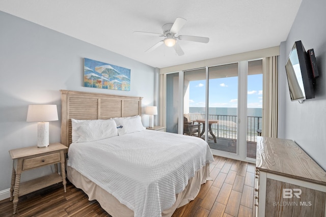 bedroom featuring access to outside, a ceiling fan, and wood finished floors