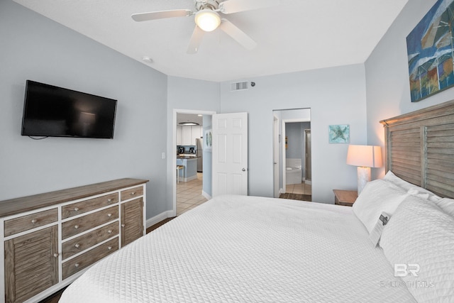 bedroom featuring visible vents, ensuite bathroom, ceiling fan, baseboards, and tile patterned floors