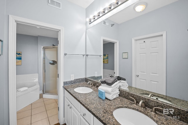 bathroom with a stall shower, a sink, visible vents, and tile patterned floors