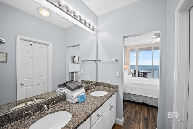 full bath with wood finished floors, a sink, and connected bathroom