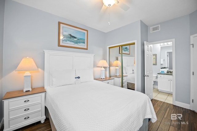 bedroom featuring baseboards, visible vents, a ceiling fan, connected bathroom, and dark wood-style flooring