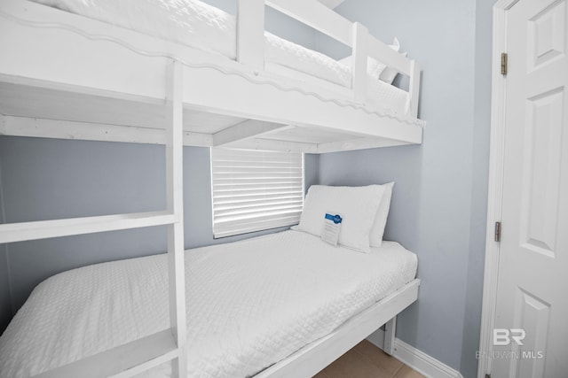 tiled bedroom with baseboards