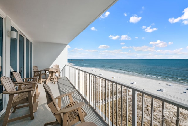 balcony with a beach view and a water view