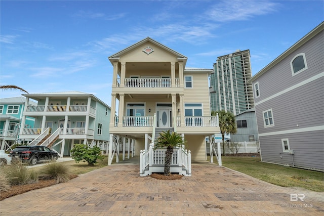 view of building exterior with a carport and decorative driveway