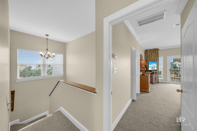 corridor featuring an upstairs landing, visible vents, a healthy amount of sunlight, and carpet floors