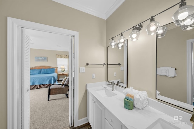 ensuite bathroom with ensuite bath, ornamental molding, double vanity, and a sink