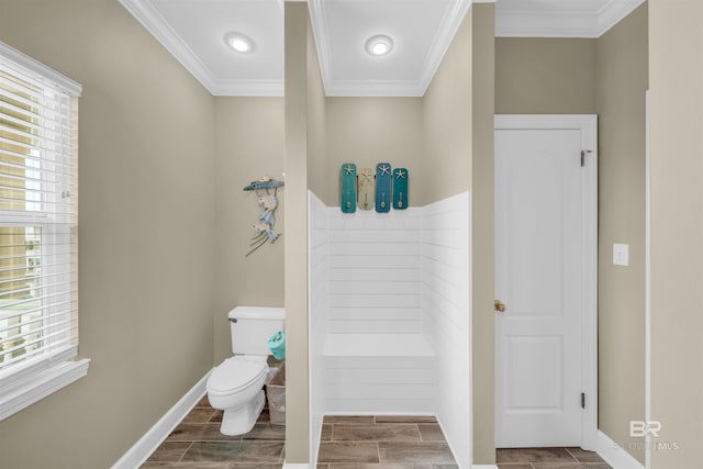 bathroom featuring a healthy amount of sunlight, toilet, and ornamental molding