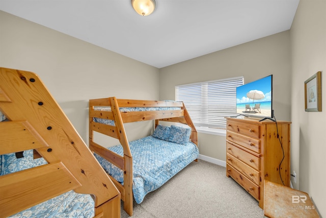 bedroom with baseboards and light carpet