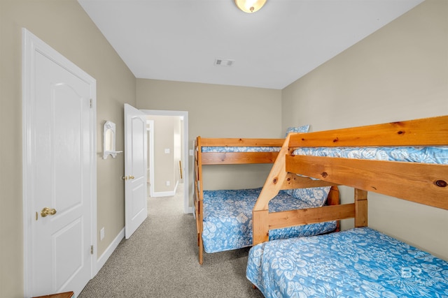 carpeted bedroom featuring baseboards