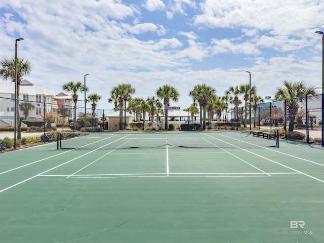 view of sport court featuring fence