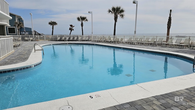 pool featuring a patio area and fence