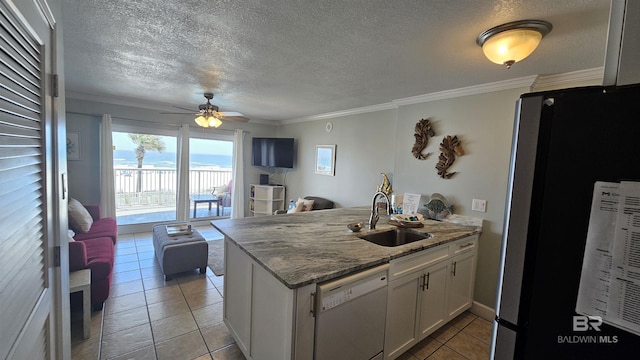 24568 Perdido Beach Blvd Unit 102, Orange Beach, AL 36561 - kitchen with white cabinetry, a sink, dishwasher, freestanding refrigerator, and a peninsula