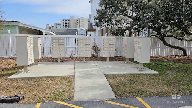 view of property's community with mail area and fence