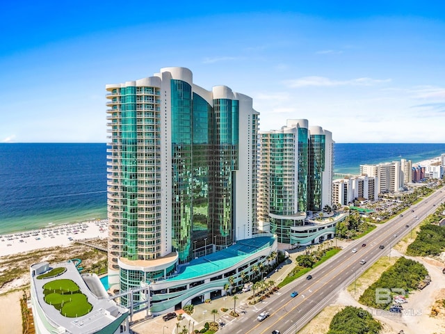 birds eye view of property featuring a water view and a beach view