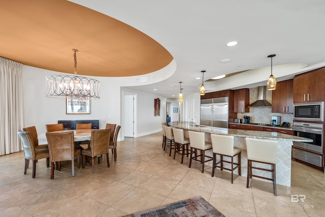 tiled dining area with an inviting chandelier