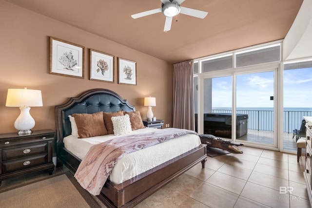 bedroom featuring access to outside, a water view, light tile patterned flooring, and ceiling fan