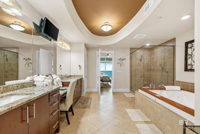 bathroom with tile patterned flooring, shower with separate bathtub, a tray ceiling, and vanity