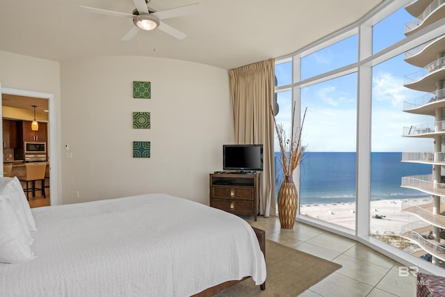 bedroom with ceiling fan, access to exterior, and light tile patterned floors