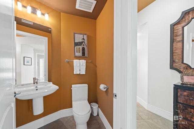 bathroom with tile patterned floors and toilet