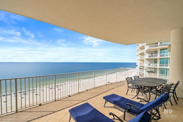 balcony with a beach view and a water view