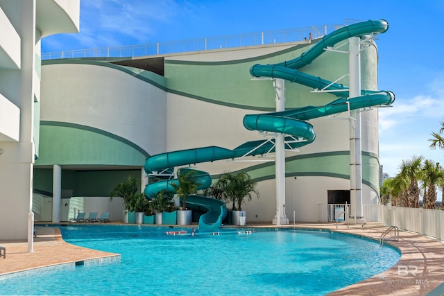 view of swimming pool with a water slide