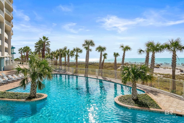 view of swimming pool featuring a water view