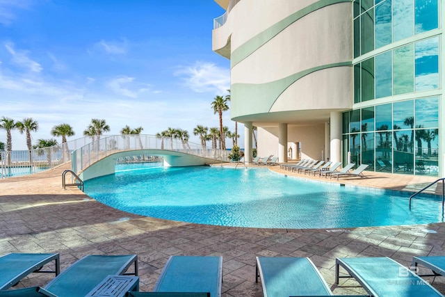 view of swimming pool featuring a patio area