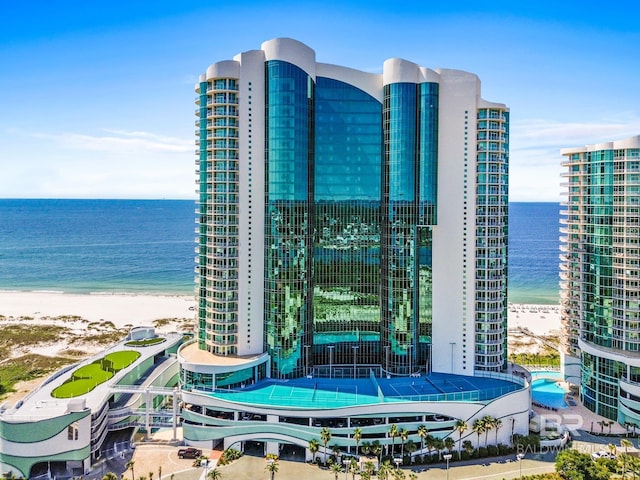 view of property with a view of the beach and a water view